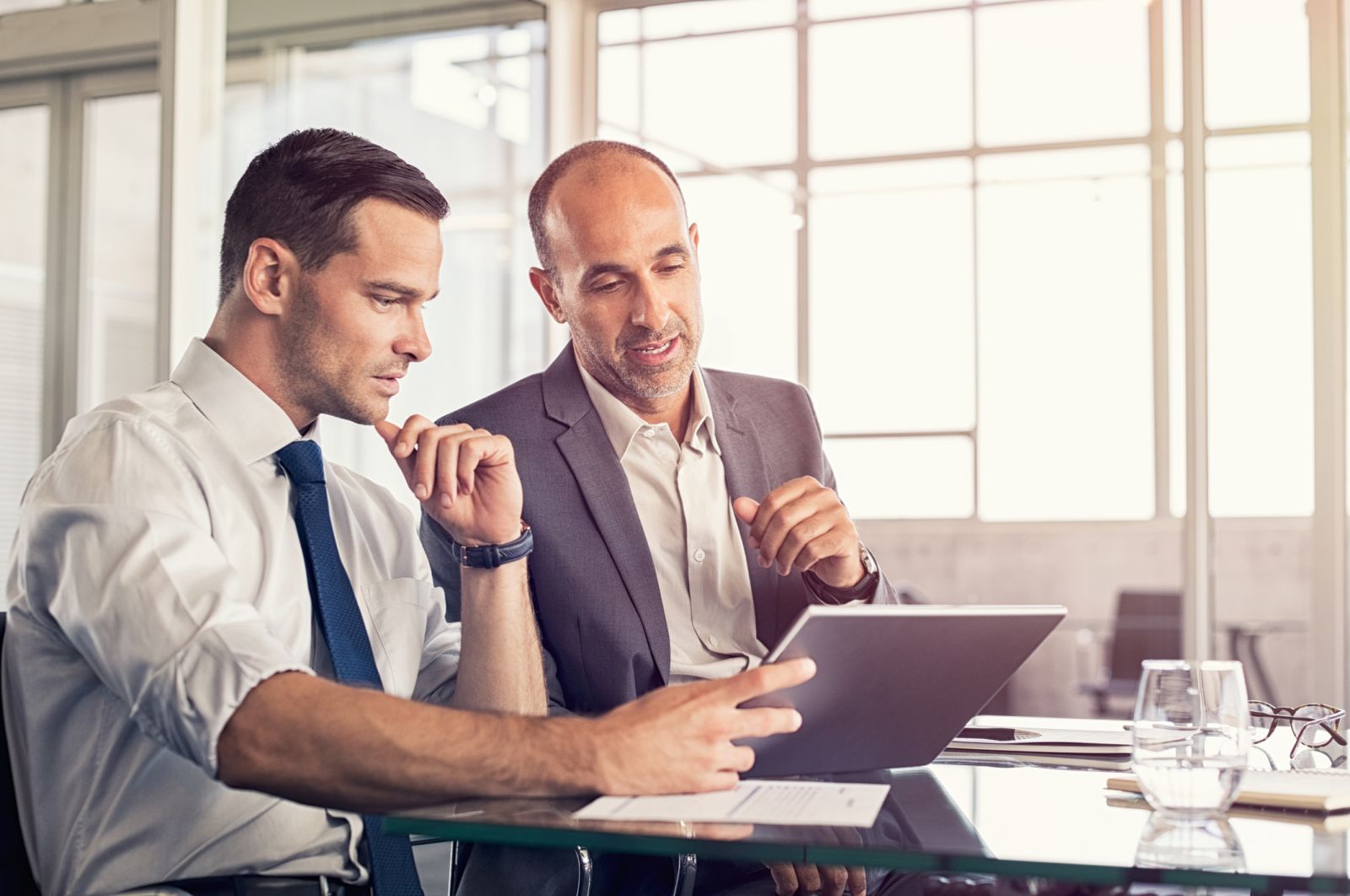 People and teaching - 2 men analyzing a report - by Ridofranz via iStock